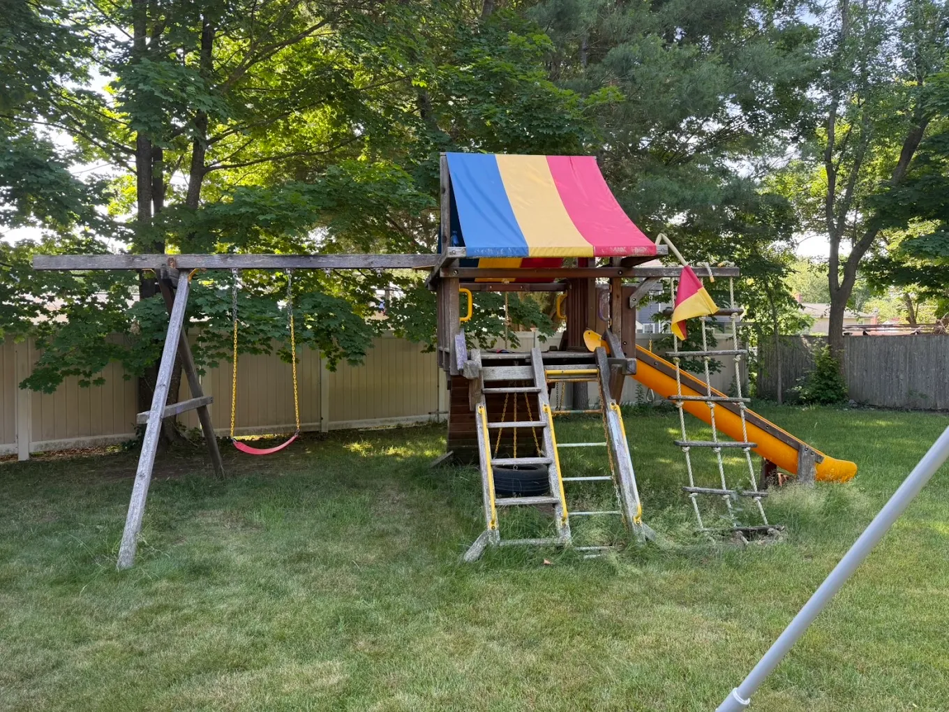 Before — Old wooden playset and swing set before removal