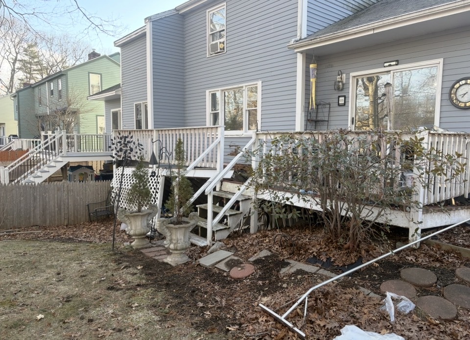 Before — Backyard deck and wooden stairs before demolition